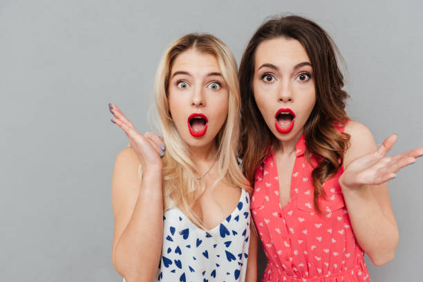 istock Shocked young two ladies friends with bright makeup lips 1356219871