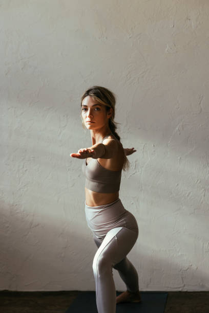 istock Young Blonde Woman Standing in the Warrior Pose 1356220879