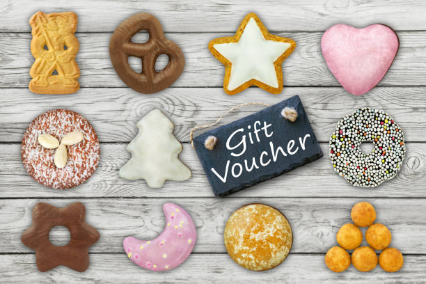 istock Gift Voucher and Christmas biscuits on wooden background 1356221166