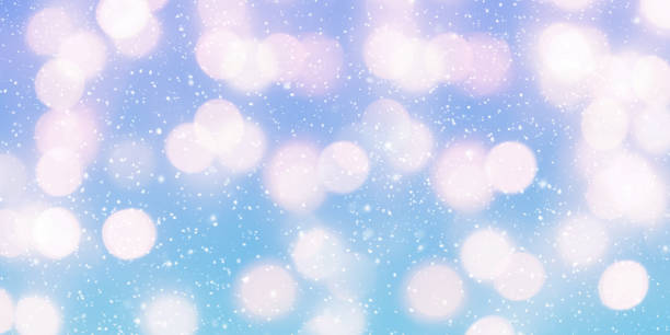 istock Abstract blue winter background with bokeh. Christmas light with falling snow. Winter panoramic scenery 1356221410