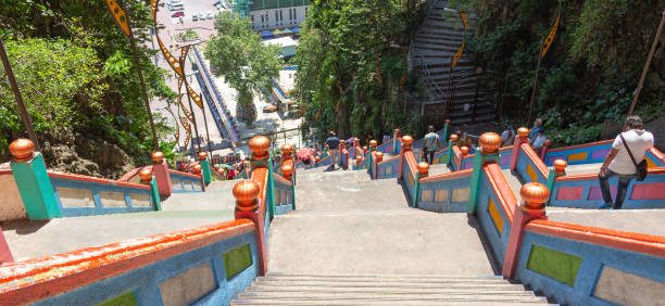 Kuala Lumpur, Malaysia - March 15, 2019: people go down and up the long stairs in Batu caves in Kuala Lumpur, Malaysia