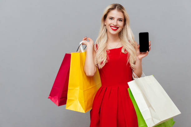 istock Blonde with phone and bags 1356221582