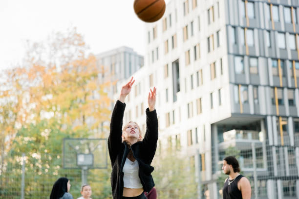 istock Girl practicing free throws on outdoors basketball court 1356222439