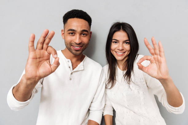 istock Happy loving couple showing okay gesture 1356222779