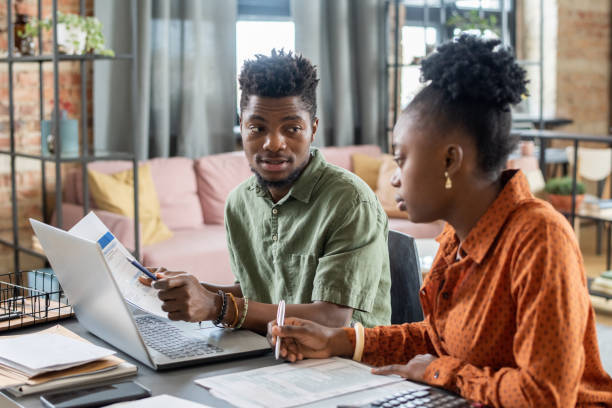istock Couple Filling Tax Returns 1356224072