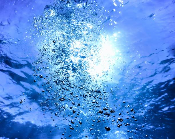 istock Underwater art of air bubbles in rays of light 1356225507
