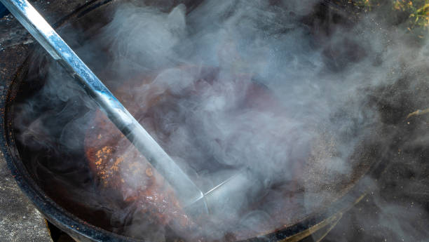 istock Mulled wine in a large cauldron. Mulled wine is cooked in a large pot. Vitamins in the traditional festival. 1356225567