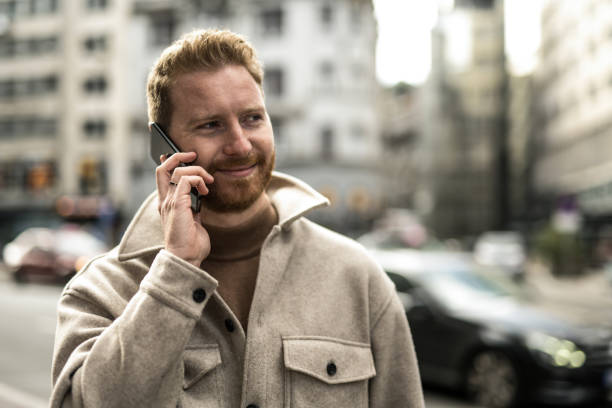 istock Happy young man in the city. 1356225789