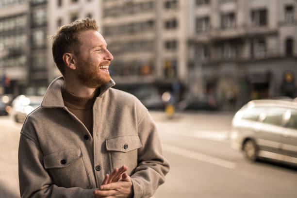 istock Happy young man in the city. 1356226722