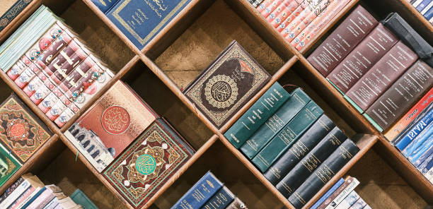Sharm El Sheikh, Egypt - October 14, 2021: Wooden bookshelf with religious books on Islam in different languages. Front view. Religion concept. Banner