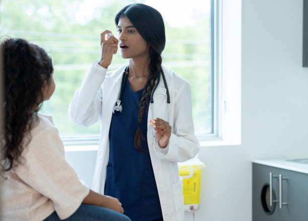 istock Doctor Instructing a Young Patient on Proper Inhaler Usage 1356226859