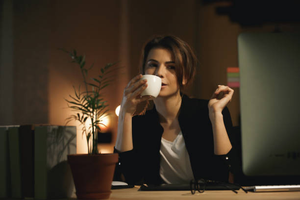 istock Concentrated young woman designer drinking coffee. 1356227319