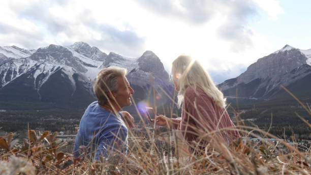 istock Hiking couple relax on grassy mountain ridge 1356227553