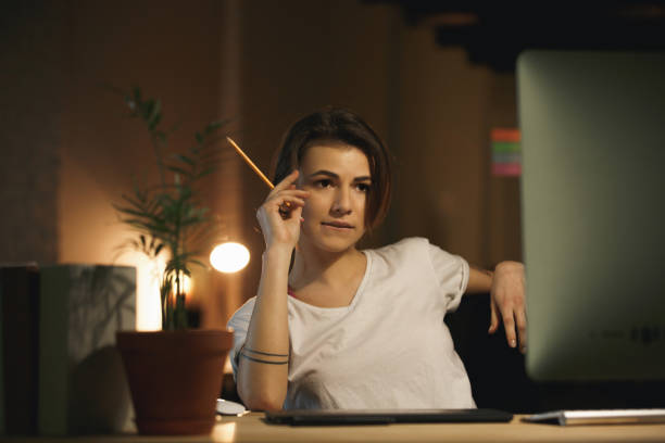 istock Concentrated young lady designer holding pencil. 1356228565