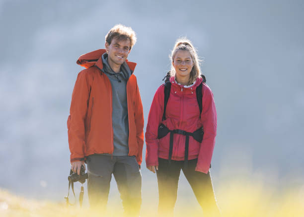 istock Hikers on mountain ridge smile at the camera 1356228821