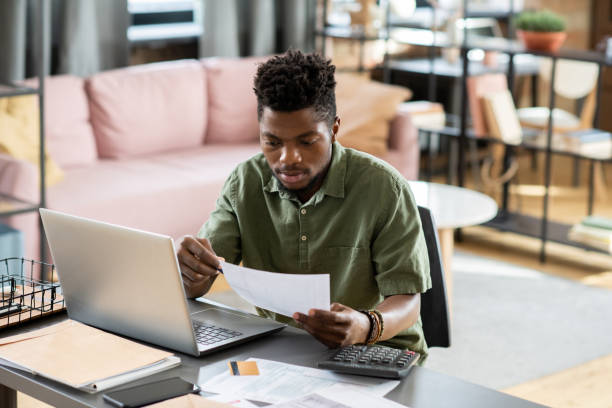 istock Young Taxpayer Checking Tax Form 1356229743
