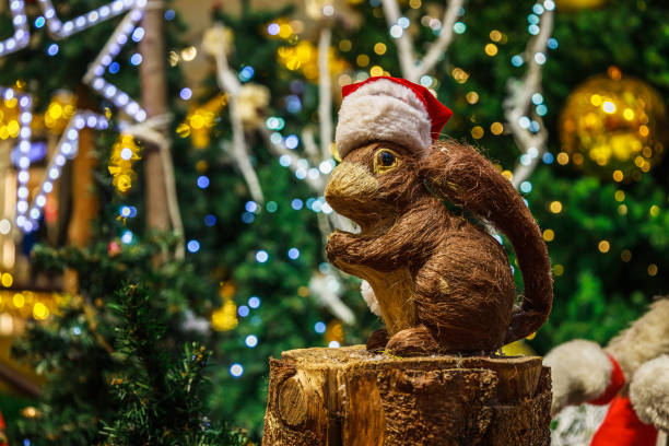 Christmas squirrel on blurry Christmas tree decoration background.