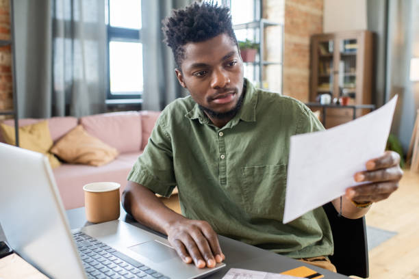 istock Young Man Examining Personal Finances 1356229952