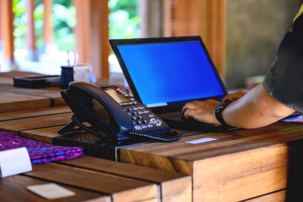 recepcjonistka hotelowa pracująca na laptopie - receptionist desk computer laptop zdjęcia i obrazy z banku zdjęć