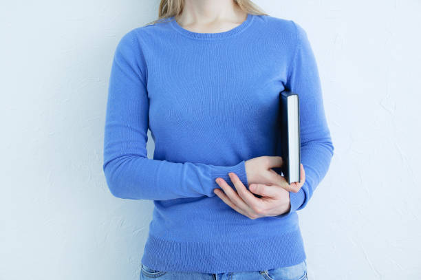 istock Caucasian woman with book in her hands. White background. 1356234178