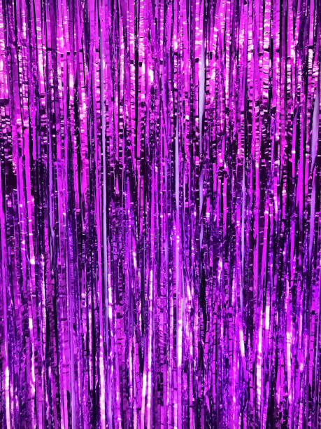 istock Festive shiny tinsel fringe, lilac background with selective focus. 1356238456
