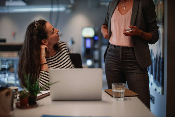 Female colleagues discussing in the office after work