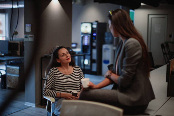 Female colleagues discussing in the office after work