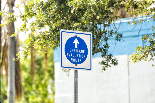 Hurricane evacuation route blue sign to shelter on road arrow direction in West Palm Beach, Florida for safety stock photo
