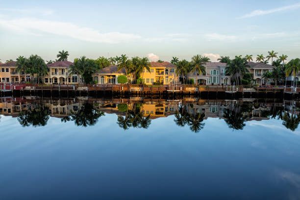 Hollywood beach in north Miami, Florida with Intracoastal water canal Stranahan river and view of waterfront property modern mansions villas houses with palm trees reflection at sunset stock photo