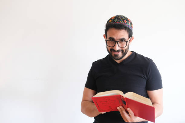 A sofer writes a Torah - the compilation of the first five books of the Hebrew Bible. The Torah is also known as the Pentateuch or the Five Books of Moses. The text is written on parchment with a quill pen and ink.