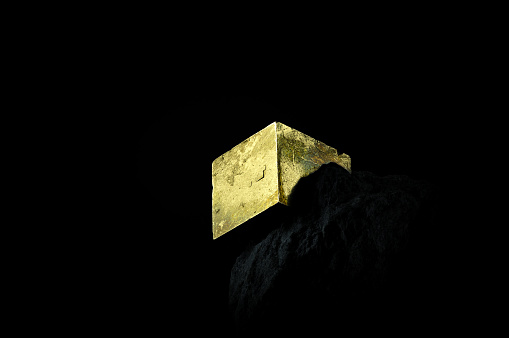 collection specimen on black background. Detail close-up macro gold color