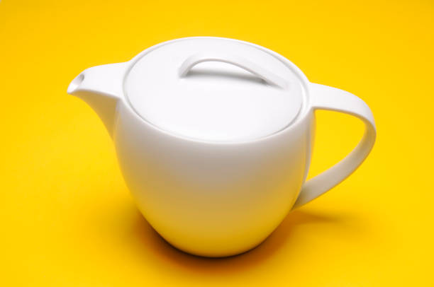 istock White Porcelain Tea Pot on Yellow Background 1356243465