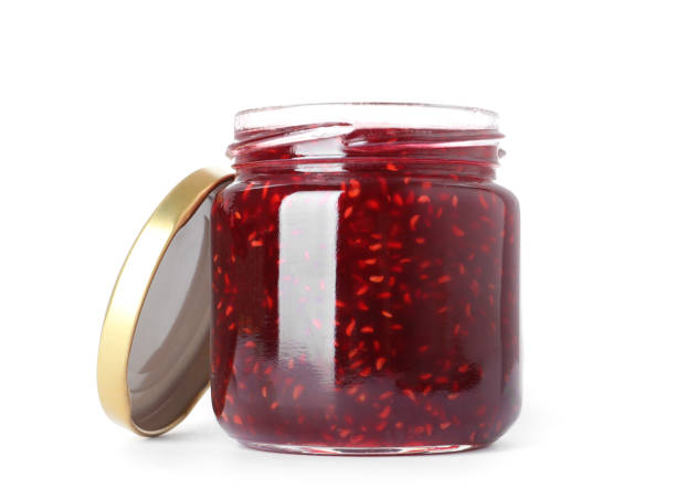istock Jar of raspberry jam isolated on white 1356245074