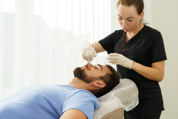 istock Young man during peeling treatment in beauty clinic 1356245327