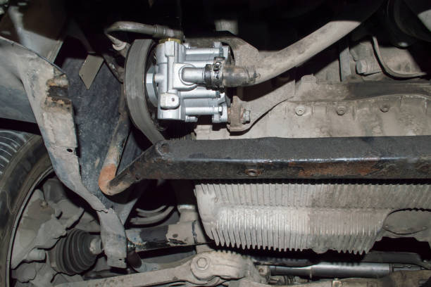 a new hydraulic power steering pump is installed on the car - hose clip imagens e fotografias de stock