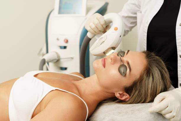 Woman client during IPL treatment in a cosmetology clinic Woman client during IPL treatment in a cosmetology medical clinic aesthetician photos stock pictures, royalty-free photos & images