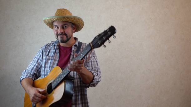 istock A man in a hat dancing with a guitar 1356246564