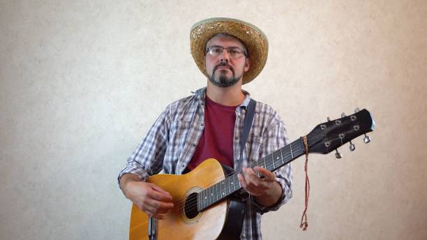 istock A man with glasses plays the guitar 1356246591