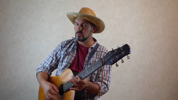 istock A man sings and plays the guitar 1356246611