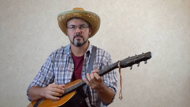 istock A man in a hat plays a funny melody 1356246623