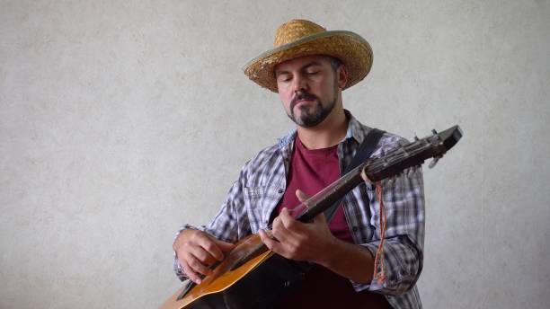 istock A man with a hat and a guitar 1356246628