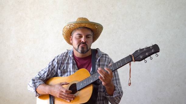 istock Man with a grimace on his face and a guitar 1356246653