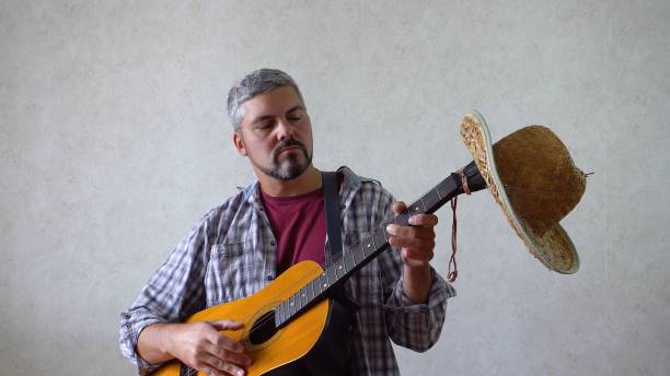 istock A man in a shirt and with a guitar 1356246661