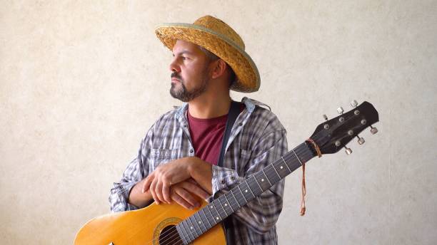 istock A man sitting with a guitar 1356246662