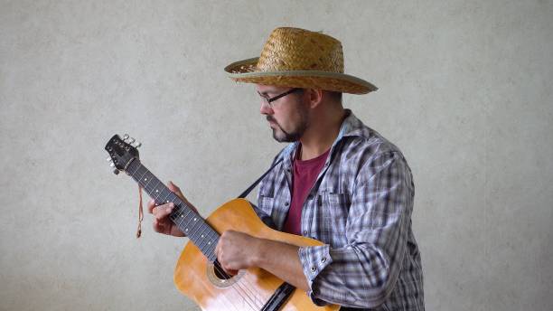 istock The musician sits sideways and plays the guitar. 1356246673