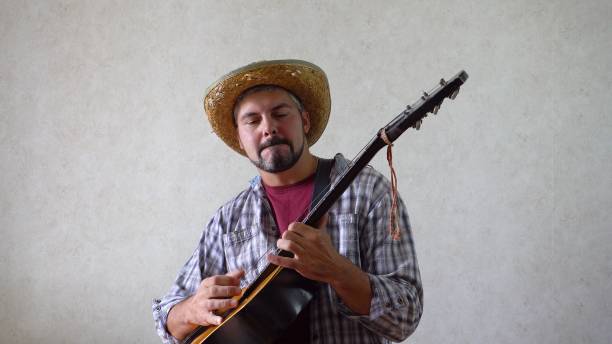 Bearded man gambling on black guitar