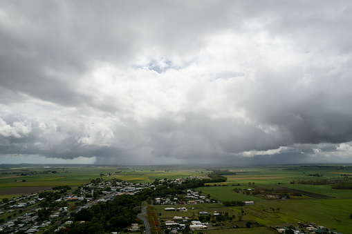 Drone aerial of thunderstorm approaching over town