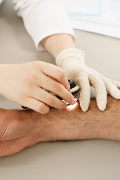 istock Dermatologist is using dermatoscope for skin examination. 1356247834