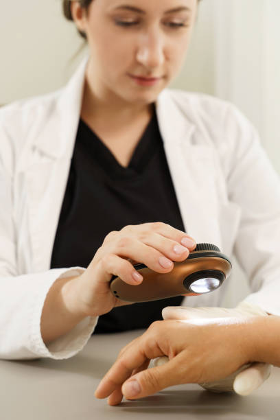 istock Dermatologist is using dermatoscope for skin examination. 1356247909