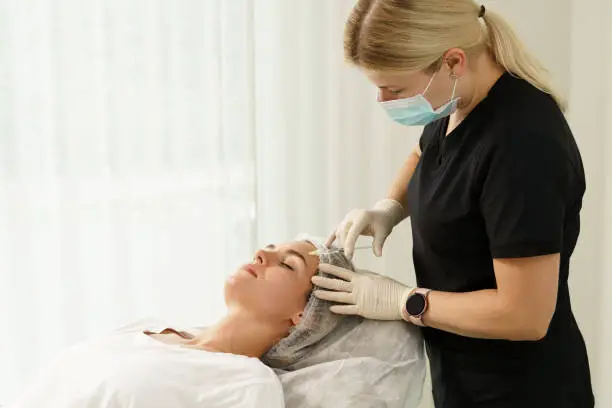 Young woman during peeling treatment in beauty clinic